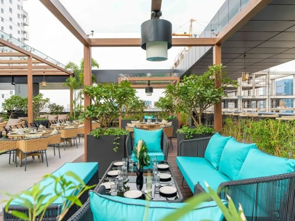 Rooftop restaurant dining setup with teal outdoor seating at Mamalola, Hyderabad